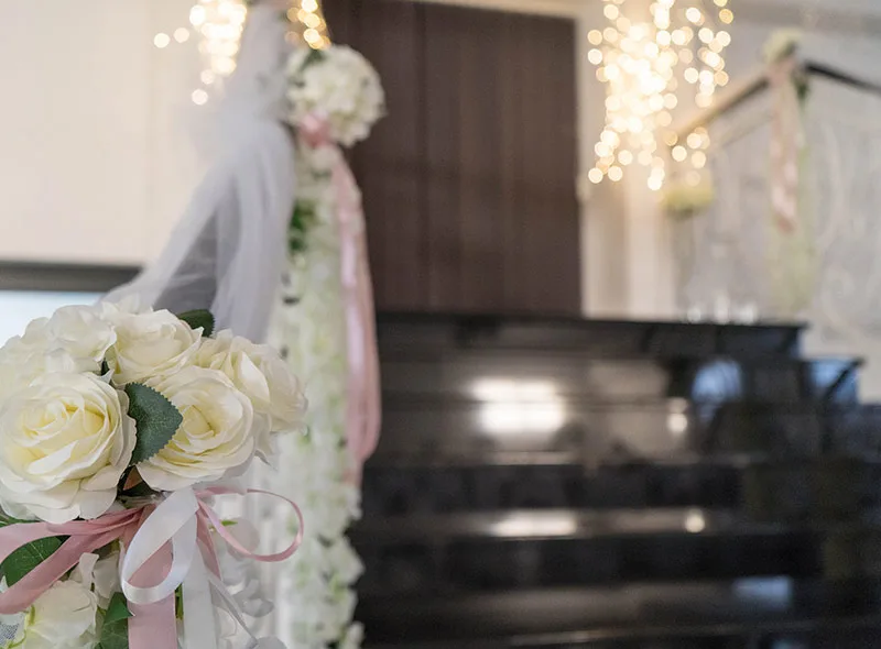 Ograda stepenica ukrašena cvijećem gdje mladenci ulaze u salu za vjenčanje.