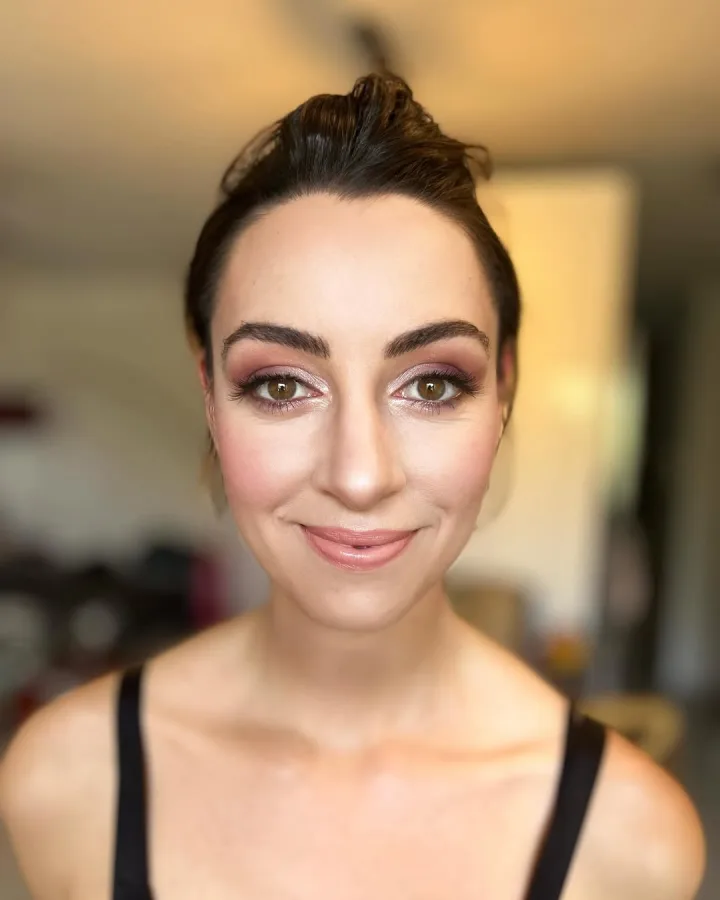 Djevojka našminkana romantično s naglašenim očima u smokey eyes stilu i nude bojom ruža.