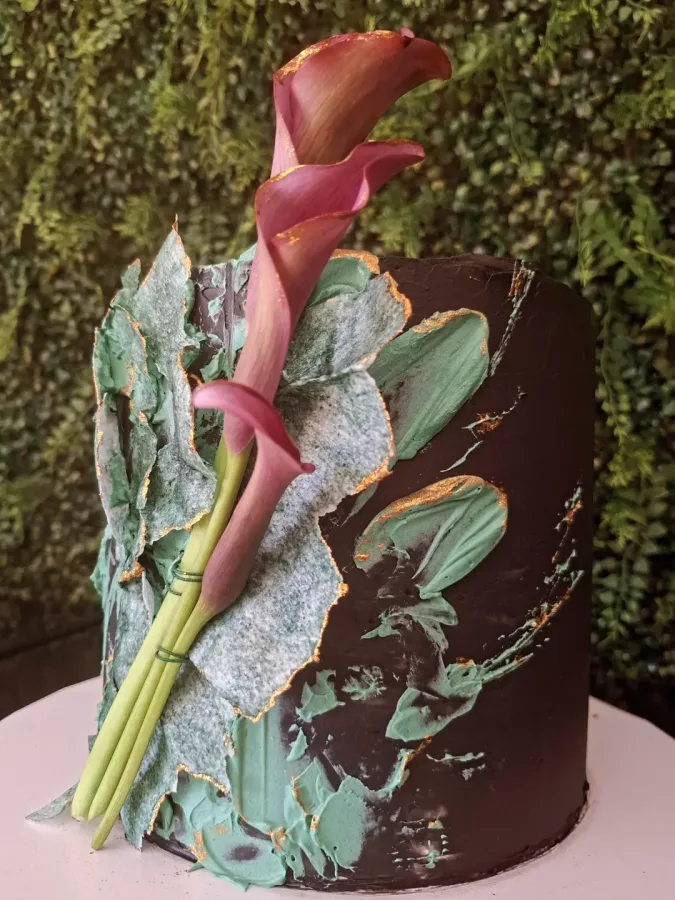 Torta dekorirana s čokoladnom kremom i cvijećem.